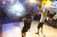 two people dancing on a dance floor in front of a crowd